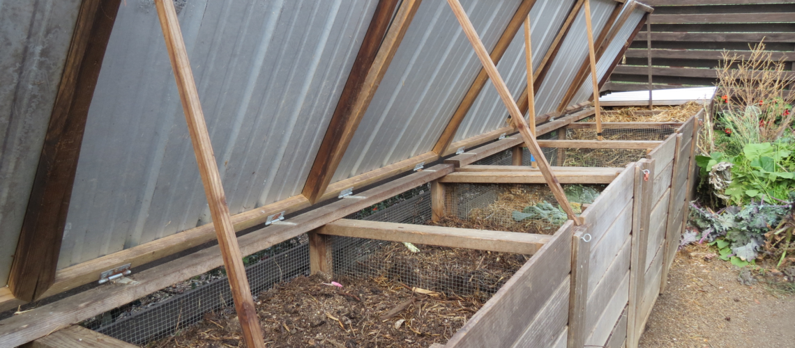 Many stages of composting from new kitchen and garden scraps to nearly finished compost.